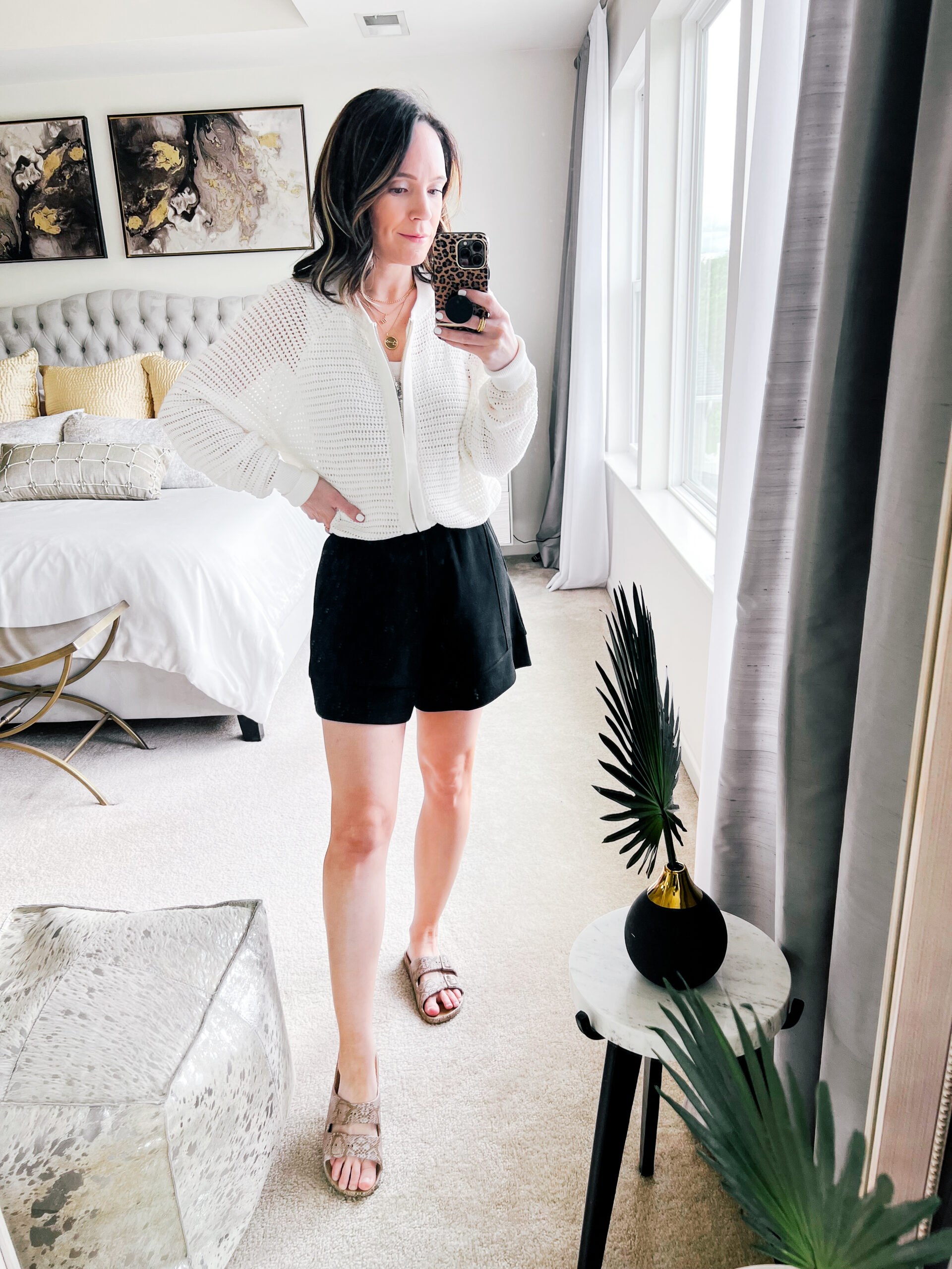 white knit sweater and black shorts