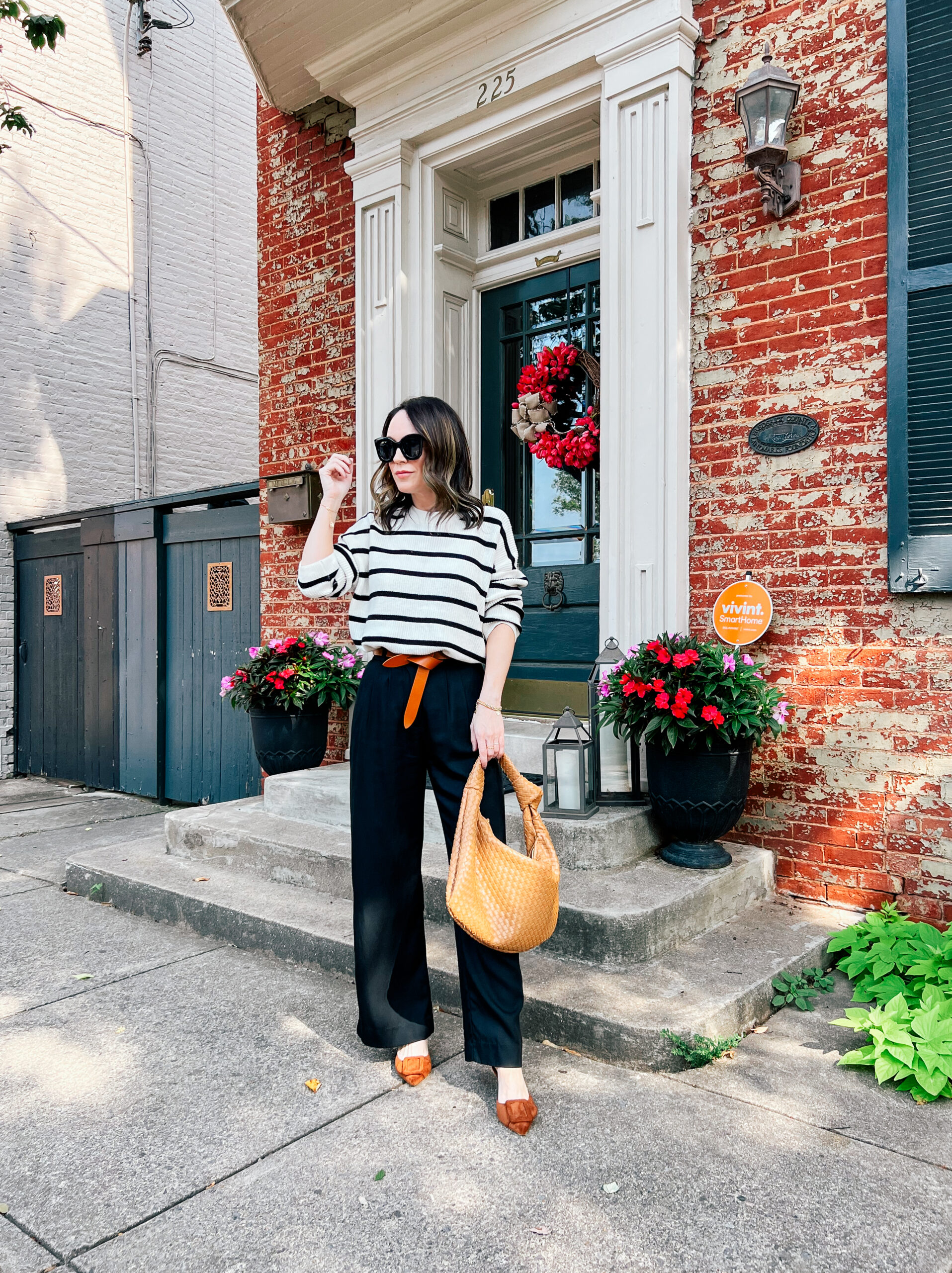 woman wearing striped sweater and black pants